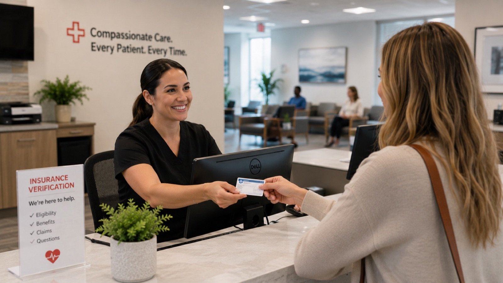 Front desk specialist verifying insurance information with a patient.